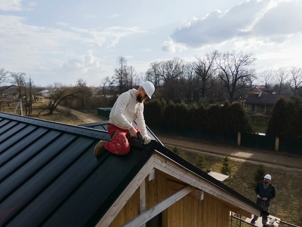 man repair house roof