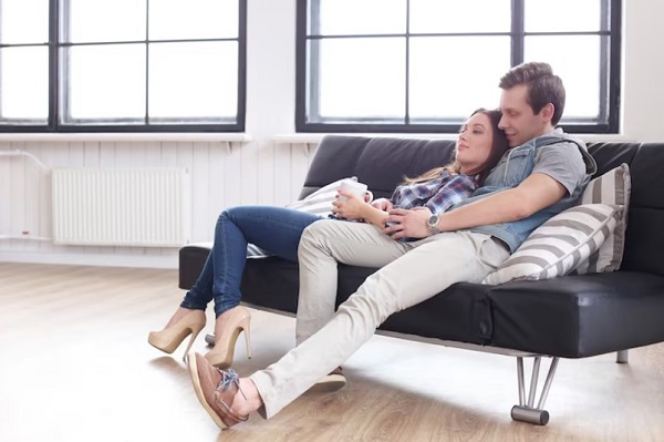 man and woman sit on Recliner Sofa