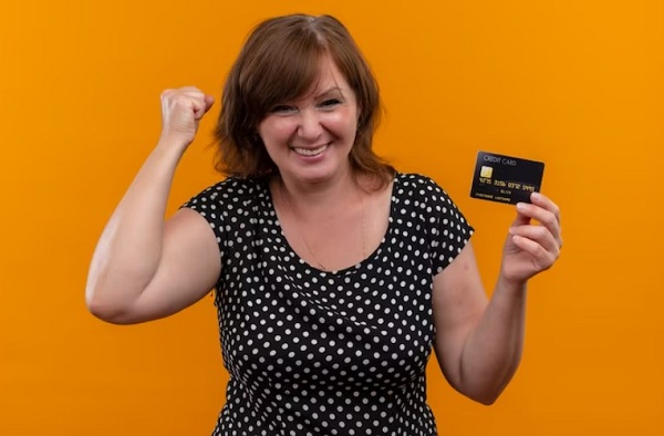 smiling woman hand holding credit cards