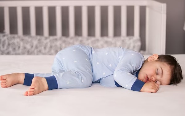baby in sleep suit
