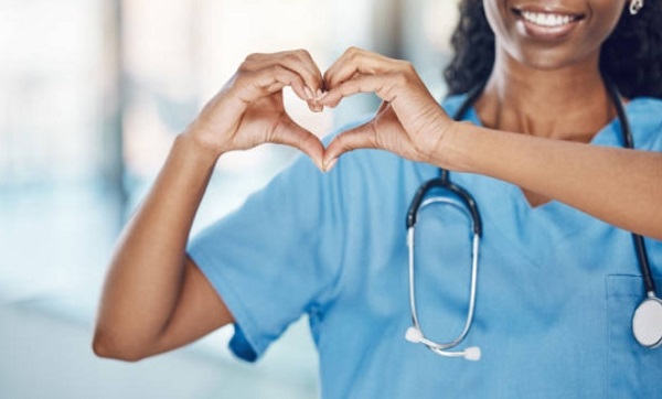 nurse making a heart hand