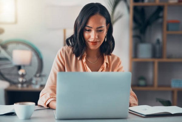 young woman typing on laptop