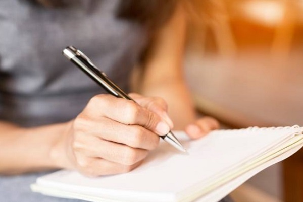 girl write on Pen with Notebook 