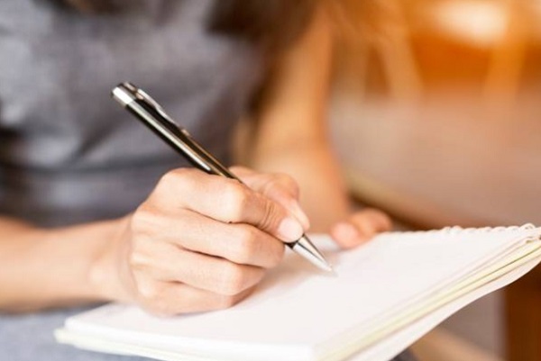 girl write on Pen with Notebook