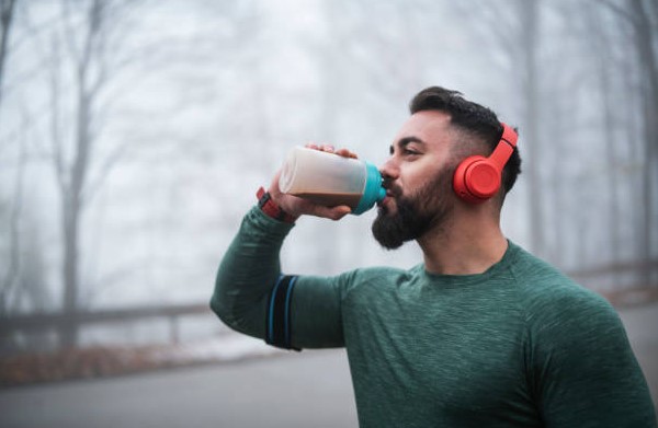 Man wear headset and drink protien shake