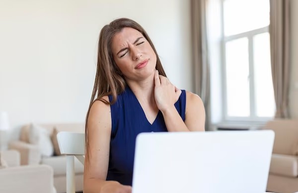 neck pain and woman using laptop