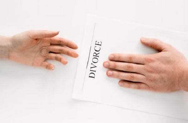 A person placed his hand on the divorce paper