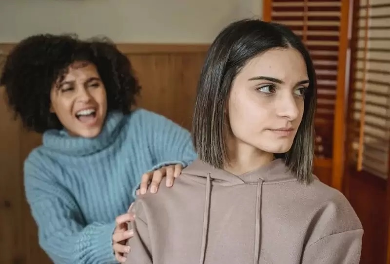 smiling girl irritate other one girl