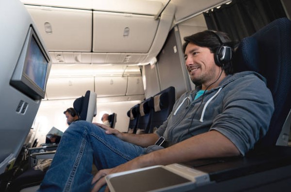 A person watch movie in flight