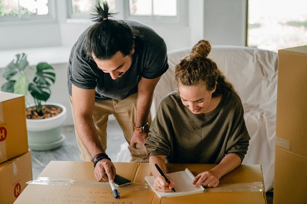 Man and woman check a Apartment Moving Checklist