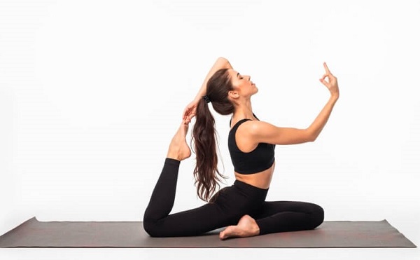 girl doing yoga and wearing black yoga dress