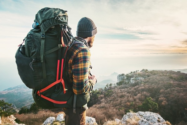 man wear a Backpacking and Hiking a mountains