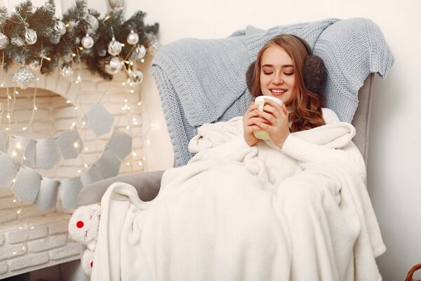 beautiful girl take tea with cozy blanket