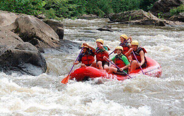 people do whitewater rafting