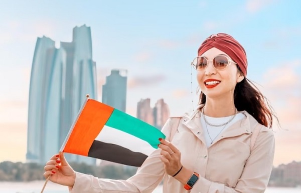Girl hand holding a UAE Flag
