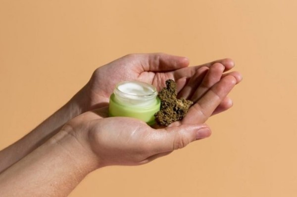 person hand holding cbd serum