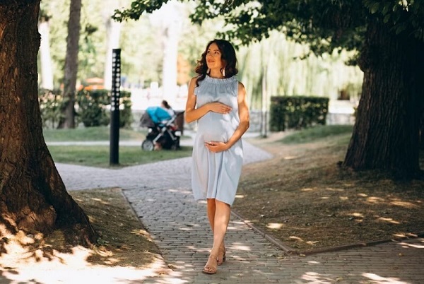 pregnant woman walking in park
