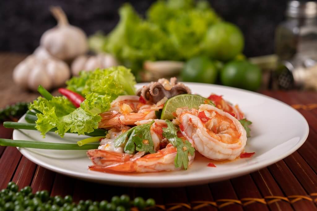 spicy squid shrimp salad white dish with lemon cilantro lettuce