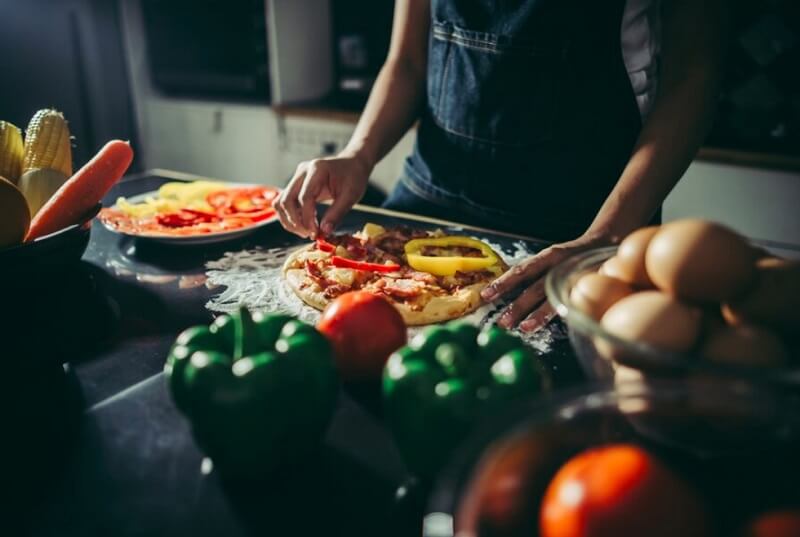 person making pizza