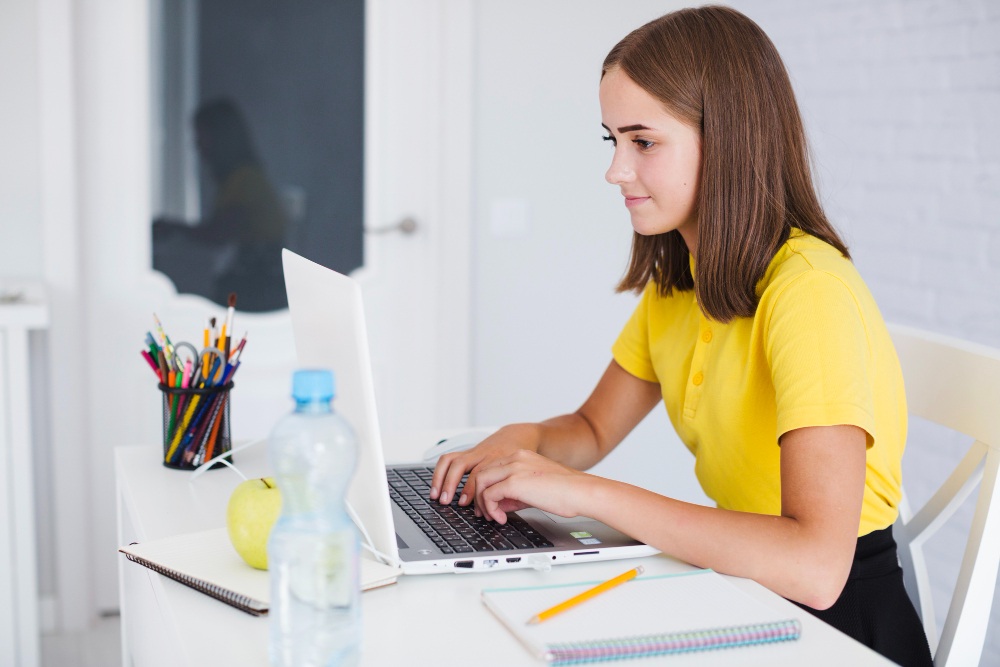 girl writing on google laptop
