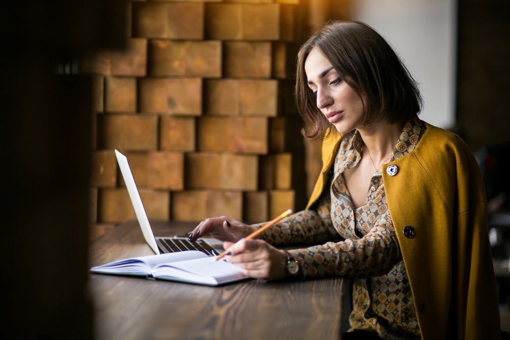 girl writing on laptop